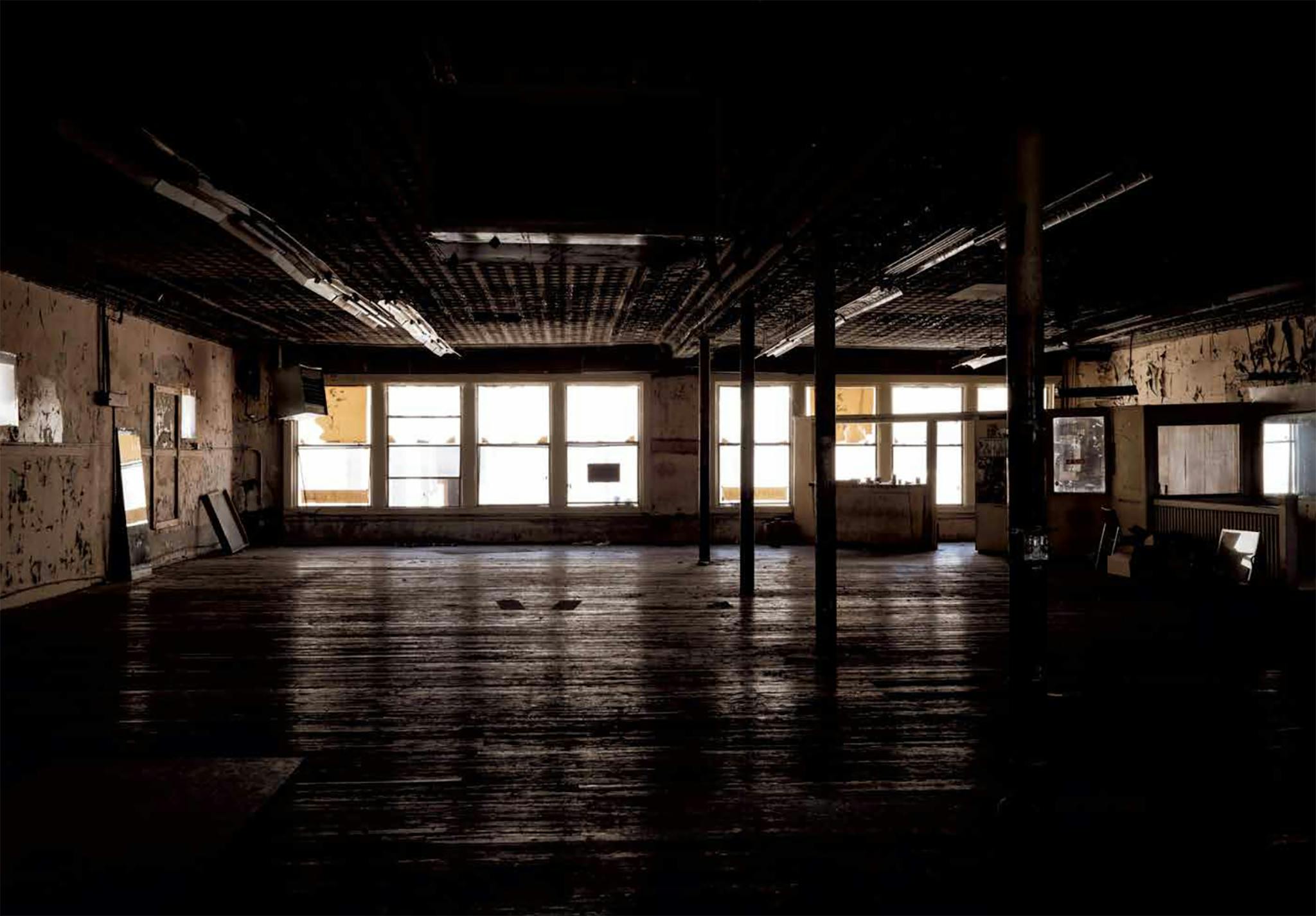 Diamond’s final photo of the gym, taken on April 16, 2018, reveals the first time the space on Commerce Street had been empty since September 1962. A few of the regulars, including one old-timer who’d been working out there from the beginning, showed up to say goodbye as the last of the equipment was being dismantled. They came to show their appreciation for Eidd and for a place aggressively unconcerned with staying up to date, a place that helped people better themselves even as it continued to deteriorate. Eidd, now 89, had the equipment moved to the backyard of the home he shares with one of his sons, an hour outside of Forth Worth. In the warmer weather, some of Doug’s regulars stop by, work out, catch up. Downtown Dallas continues to change but the second-floor space that once held Doug’s Gym sits empty. The sign still hangs where it always has, over the street, seemingly weightless.