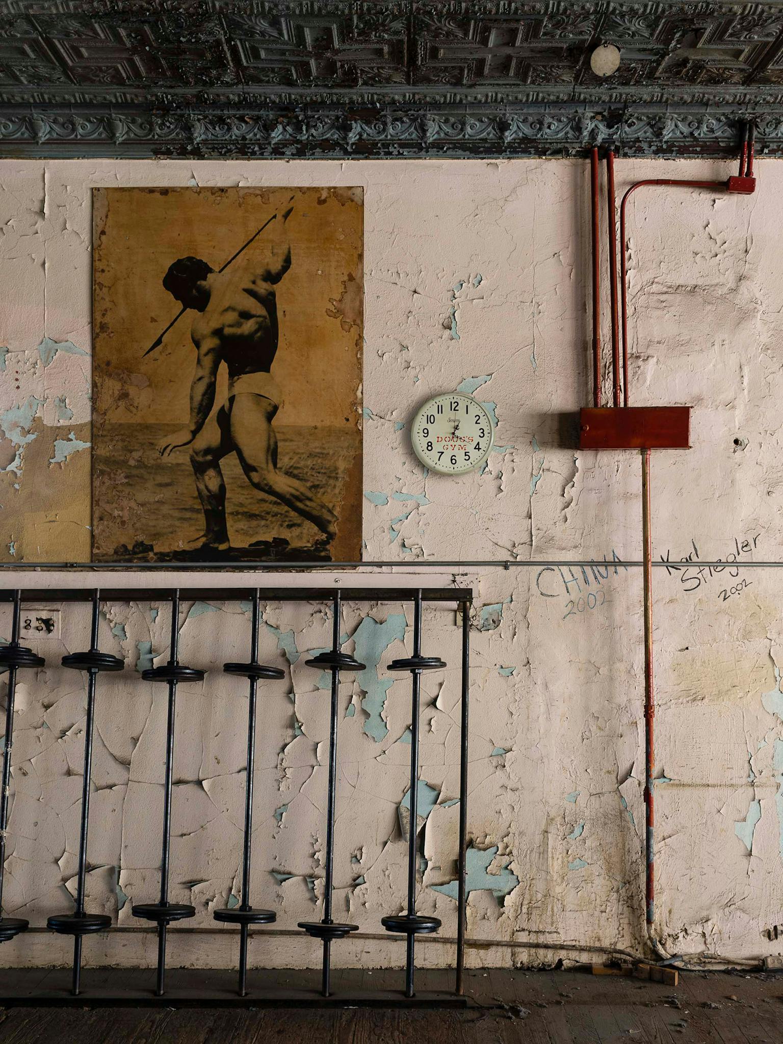 Of the more than 3,000 pictures Diamond took, this is one of his favorites. There’s a starkness to the image, but mostly a sense of decay: the faded poster (of ’36 Olympian John Grimek), the fossilized floor, all that slowly peeling paint.