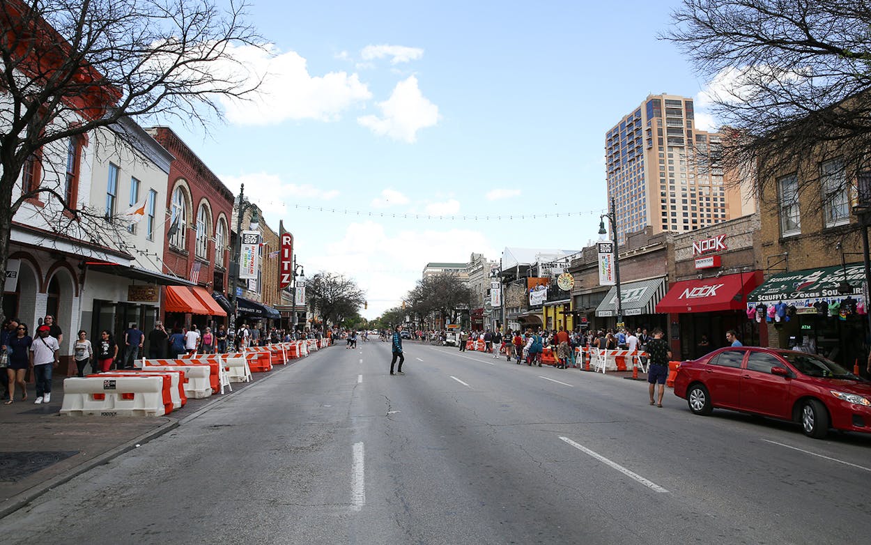Crowds walk down Sixth Street during South By Southwest on Saturday, March 12, 2016, in Austin, Texas.