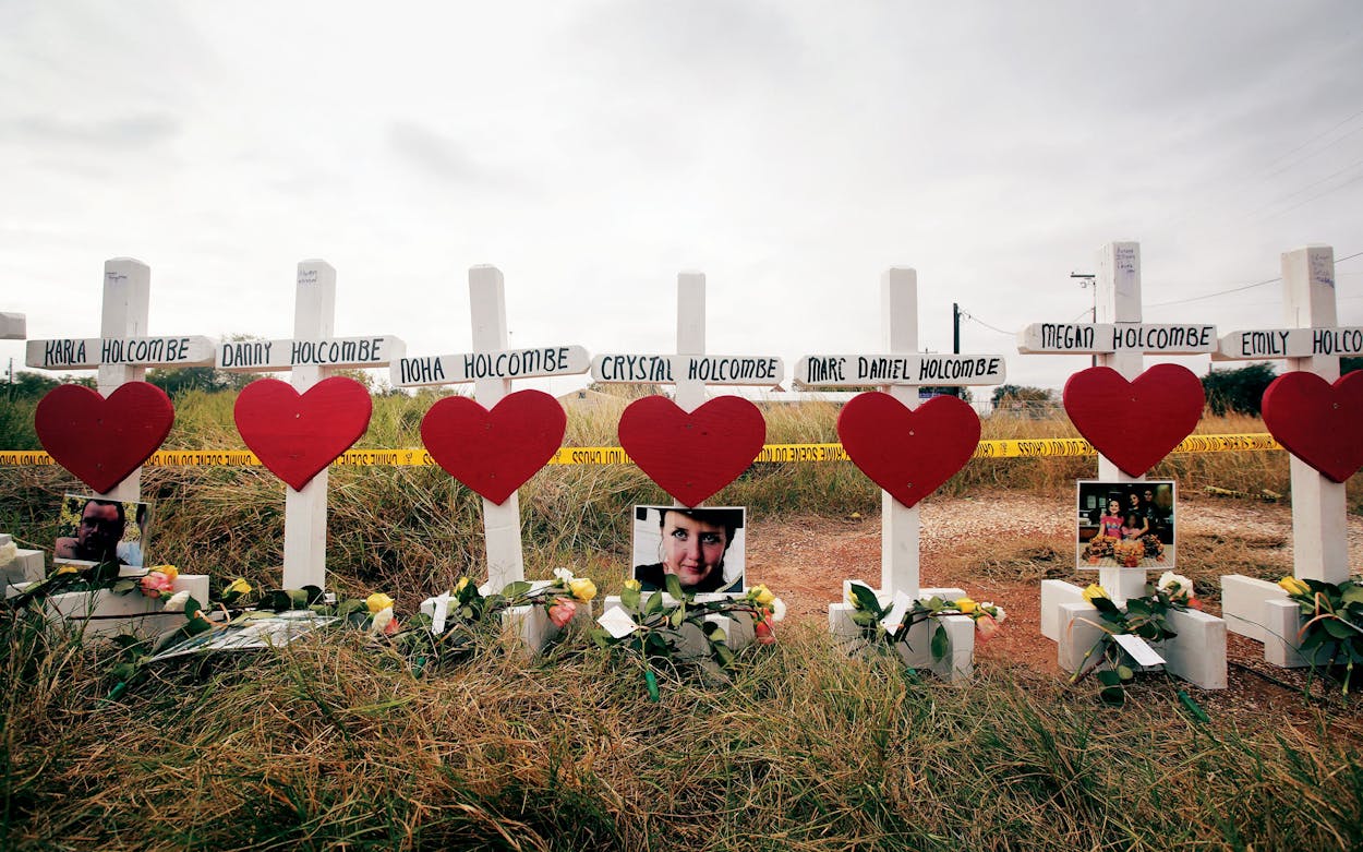 Crosses for the Holcombe family and others sit just outside crime scene tape along Highway 87 near the First Baptist Church of Sutherland Springs to honor the 26 victims killed there on November 5, 2017.