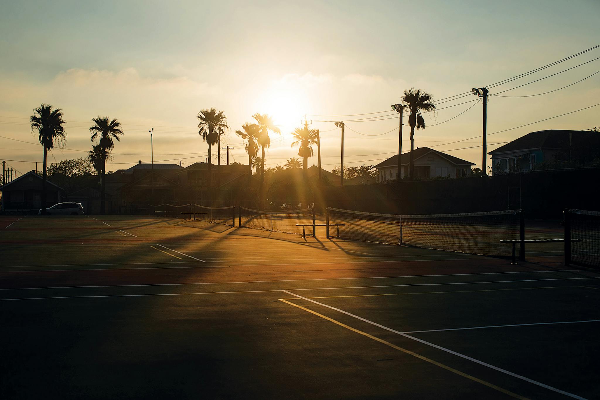 Tennis courts go unused at Menard Park, in Galveston, which began closing public spaces, including beaches, in late March.