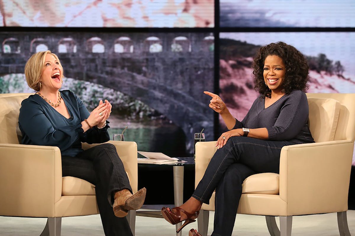 Brené Brown and Oprah laugh together. 