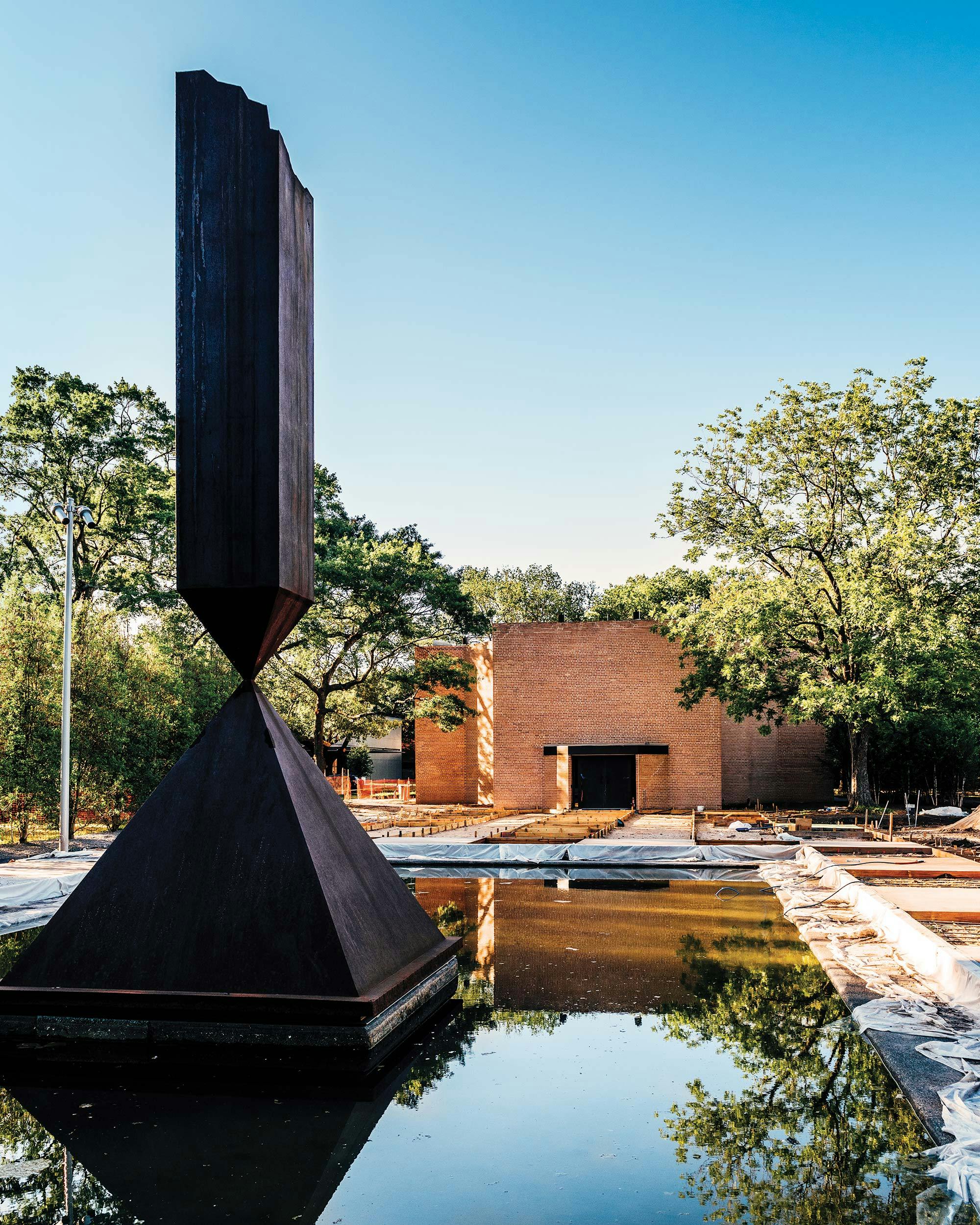 Broken Obelisk sculpture sits in a fountain in front of the Rothko Chapel. 