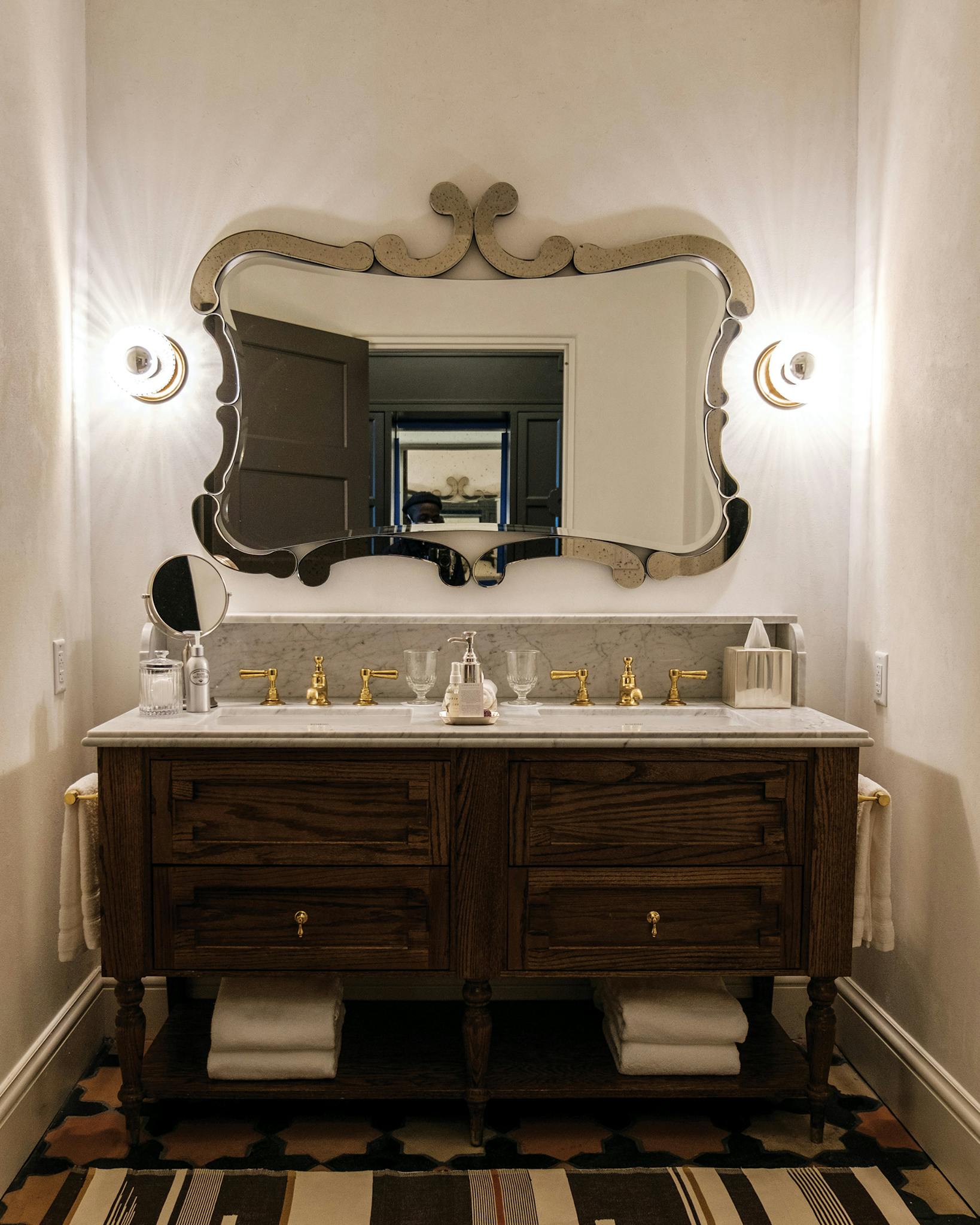 Ornate mirror and vanity in a bathroom at Commodore Perry.