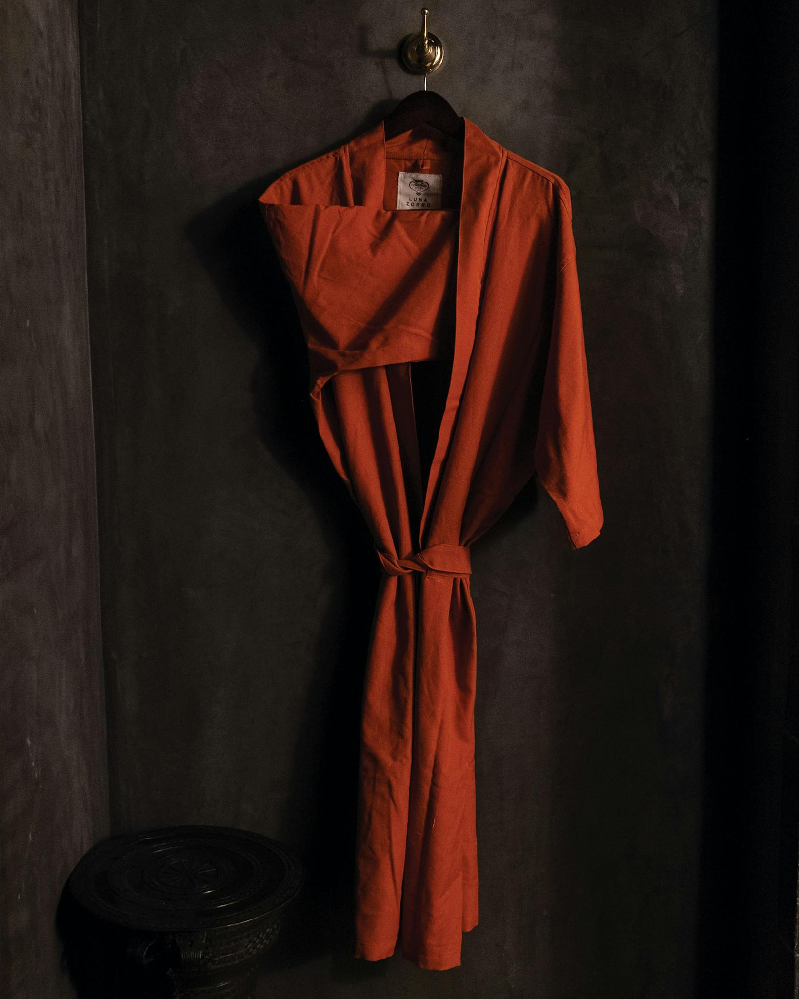 Hanging linen robe in the dark.