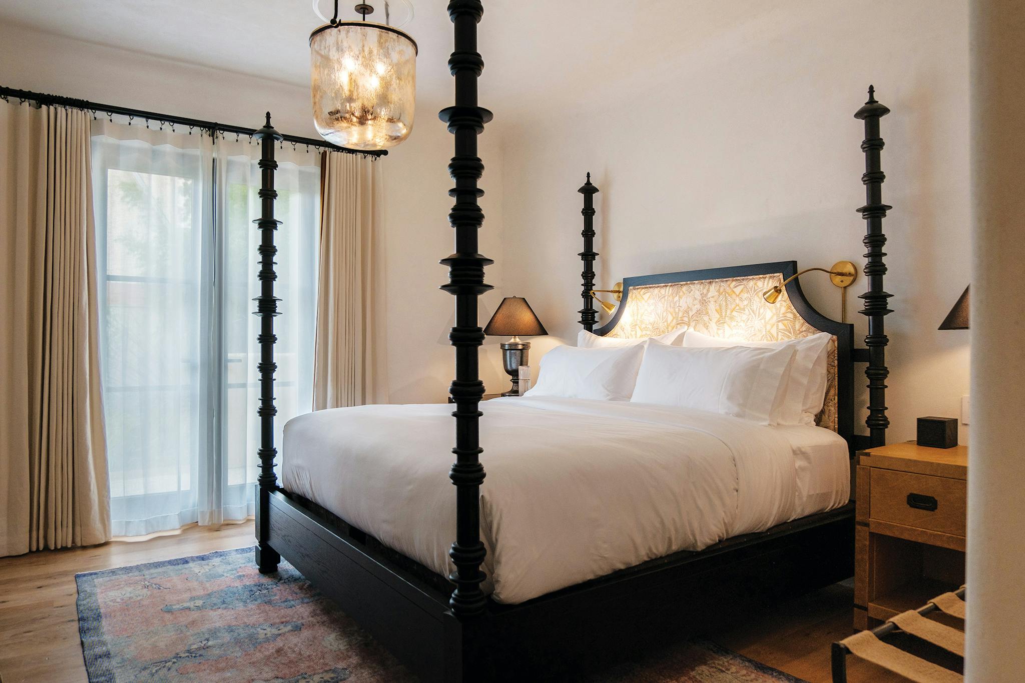 Antique light fixture, tall bed posts, and soft lighting in the Commodore Perry's new rooms.