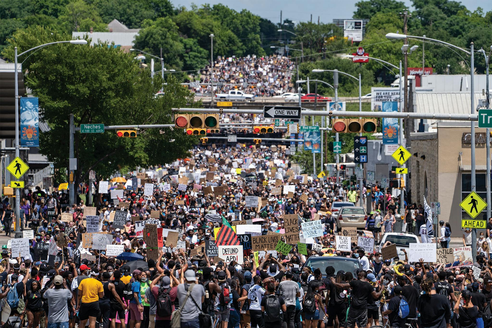 Protesters march west on 7th St through downtown Austin on June 7, 2020. The march began at Huston-Tillotson University as a rally for Black Lives, organized by the Austin Justice Coalition. An estimated 6,000 people participated in the march, despite the ongoing coronavirus pandemic.