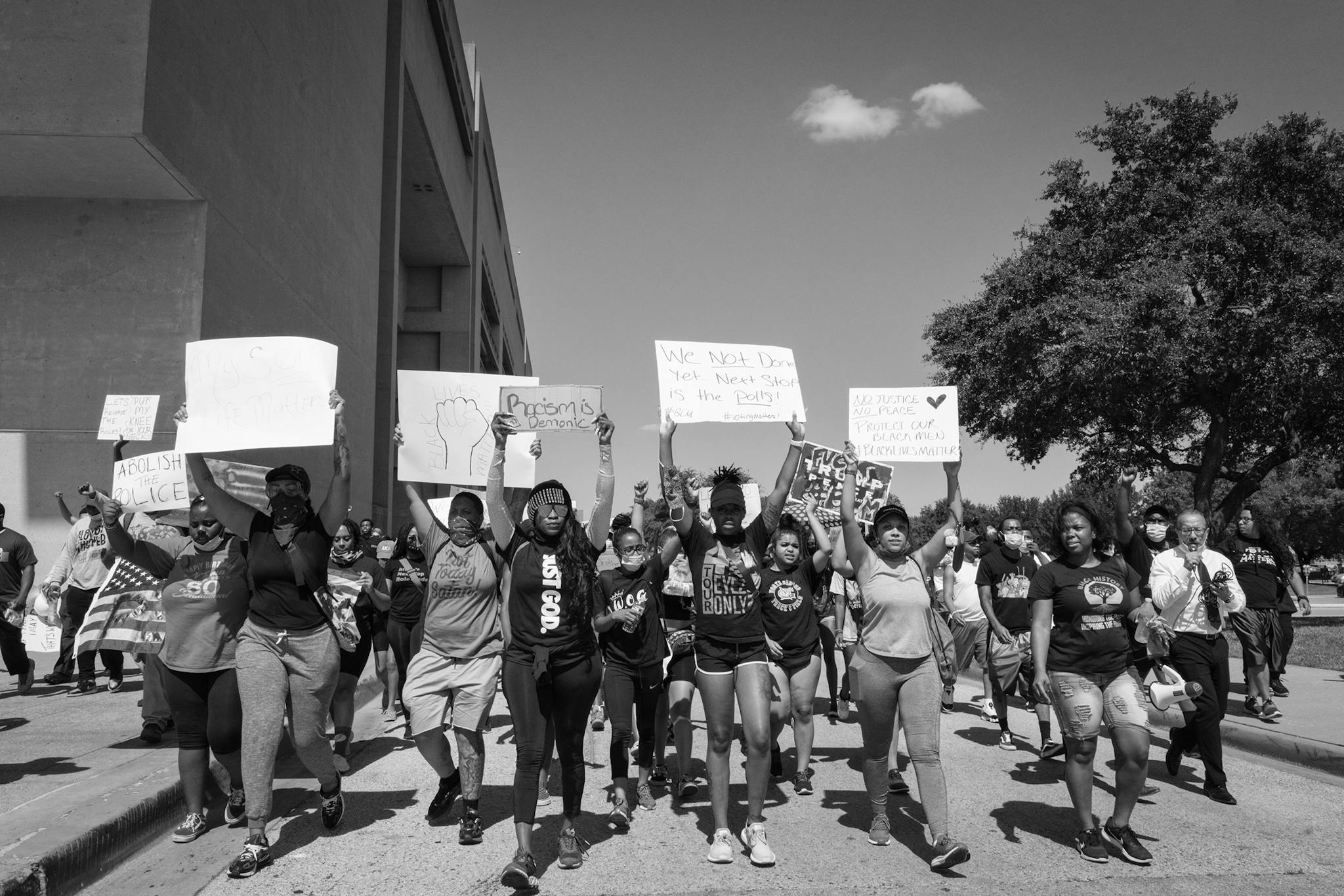 A crowd chants "I can't breathe!" as they march past Dallas City Hall on June 3, 2020.