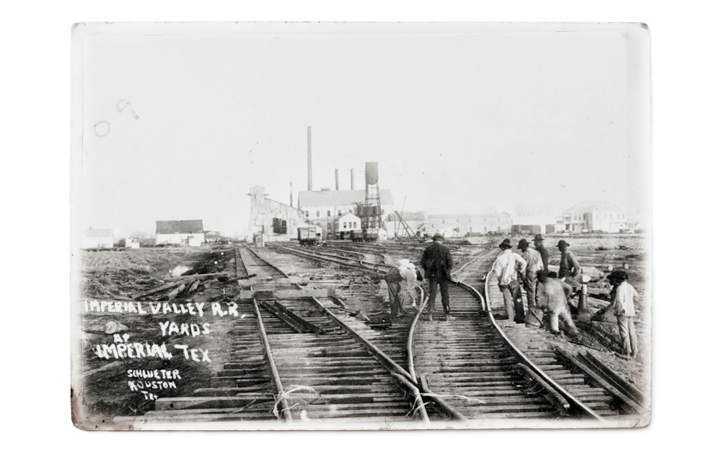 A crew repairing Sugar Land Railroad lines in 1909. (The mill can be seen in the distance.)
