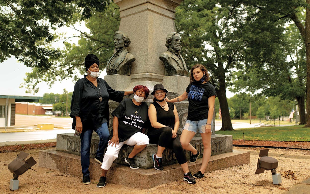 From left, Brenda Cherry, Carolyn Williams, Latrel Lacy, and Taisley Scroggin in front of the Confederate statue at the Lamar County Courthouse on July 4, 2020. They are requesting that the monument be moved.