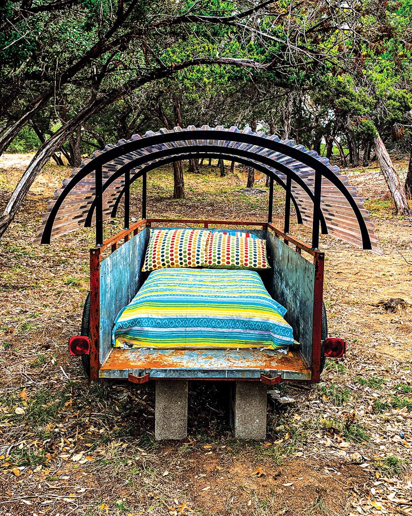 An old wagon serves as a daybed at Seco Ridge Campground, in Utopia.