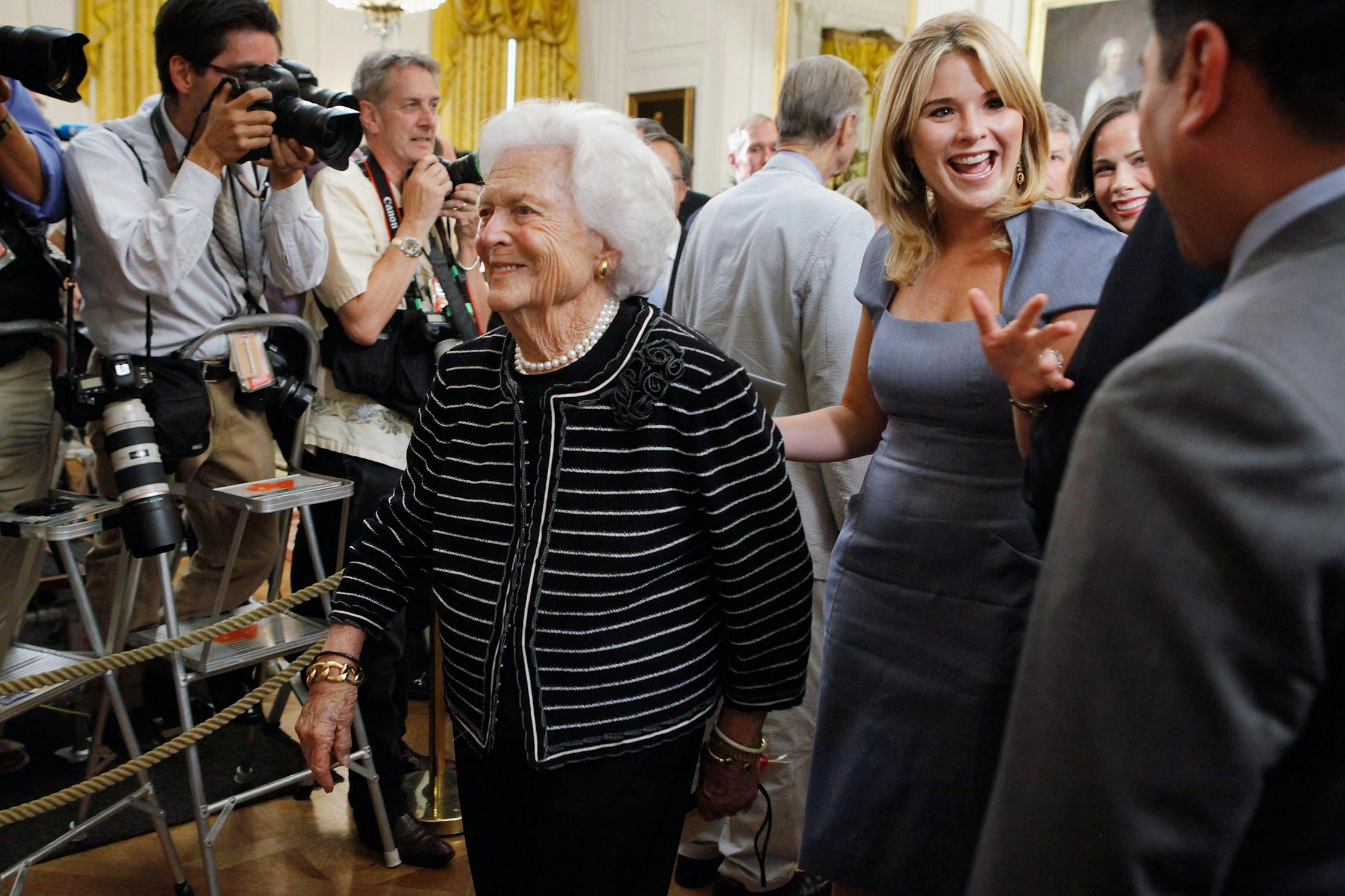 Barbara Bush and granddaughter Jenna Bush Hager walking through a crowd at the White House