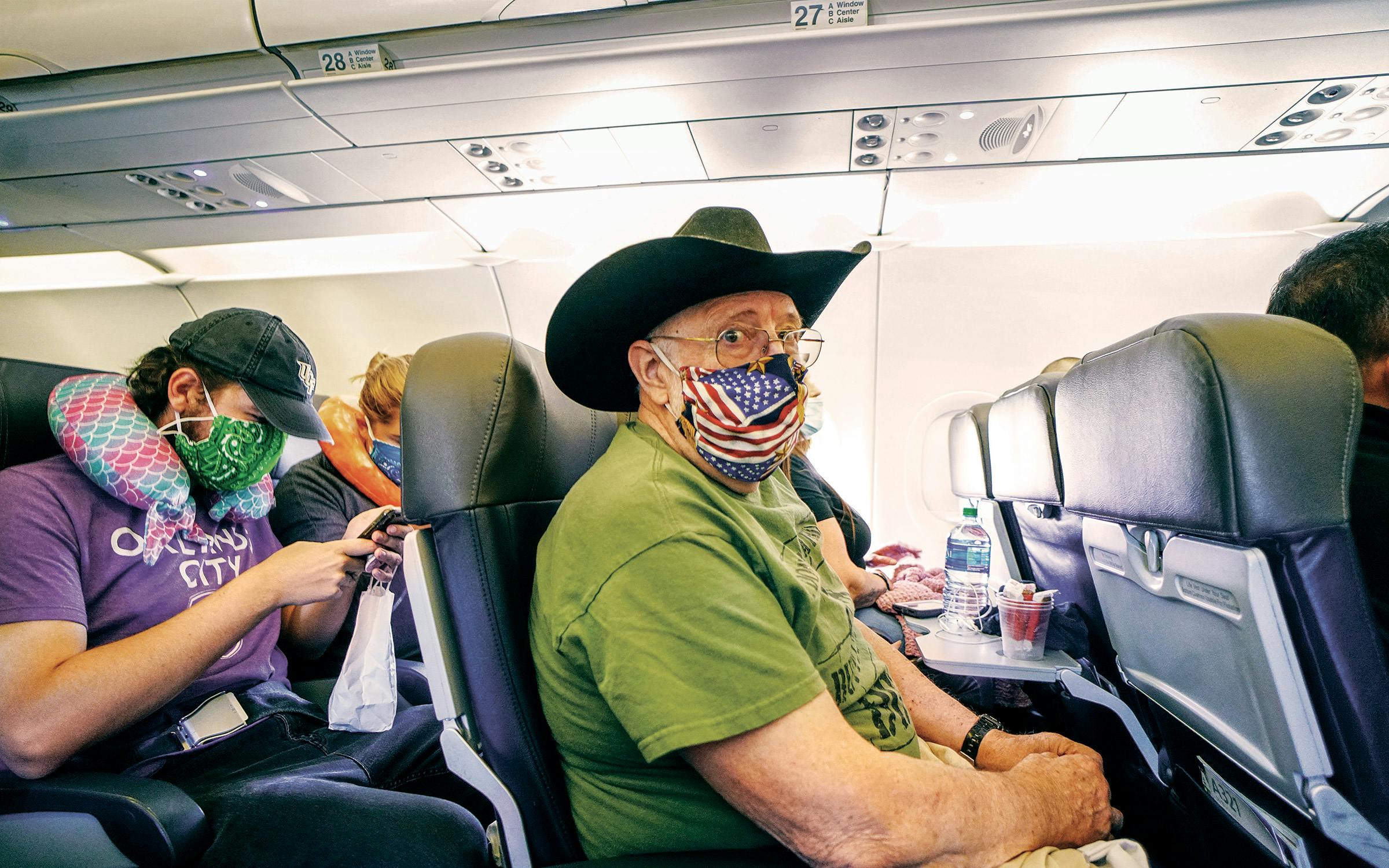 Passengers taking pandemic precautions.
