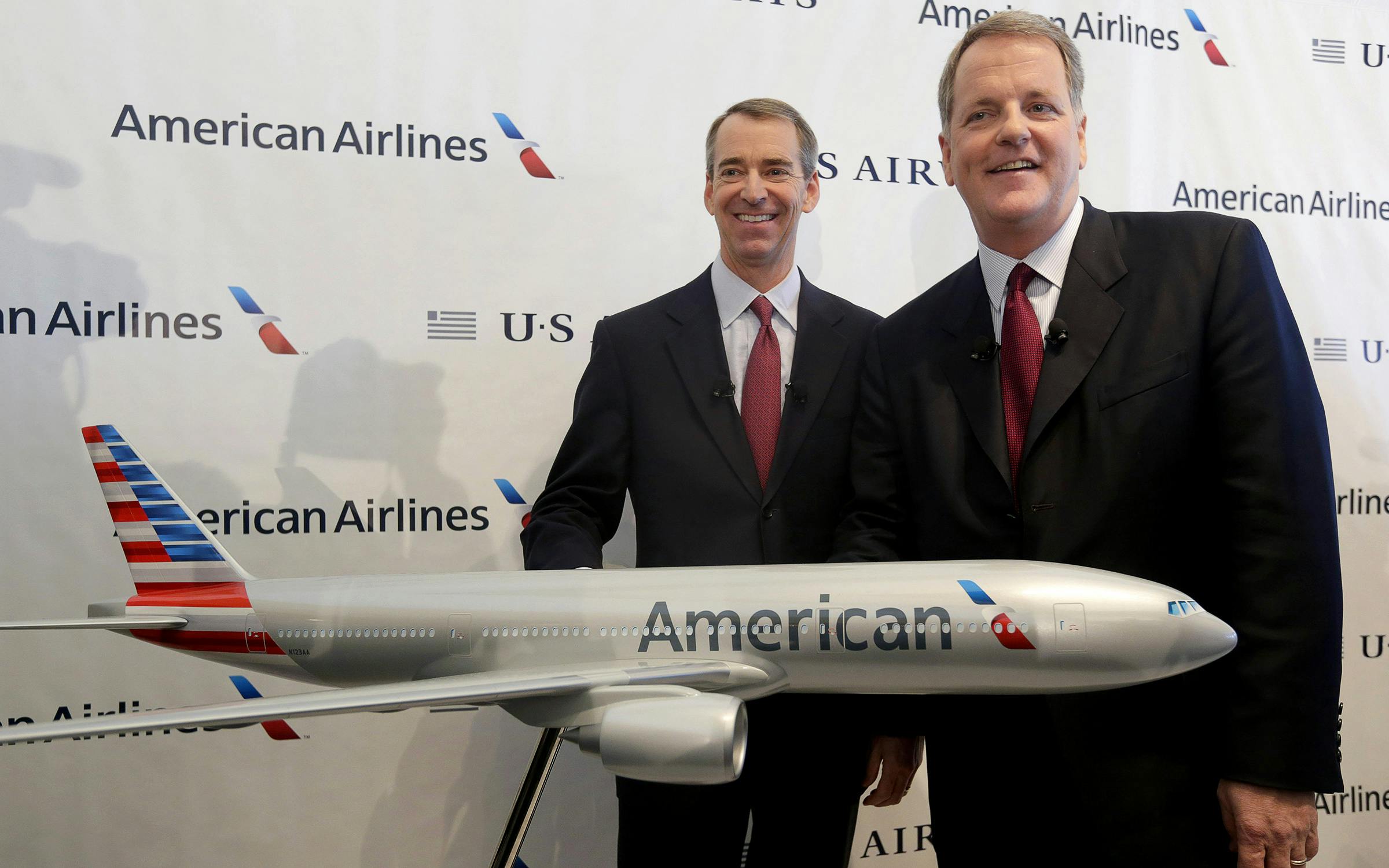 U.S. Airways CEO Doug Parker, right, and American Airlines CEO Tom Horton pose after a news conference at DFW International Airport Thursday, Feb. 14, 2013, in Grapevine, Texas. The two airlines will merge forming the world's largest airlines.