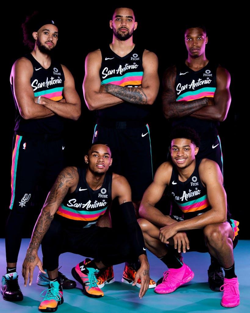 San Antonio Spurs players in the Nike City Edition Fiesta jerseys.