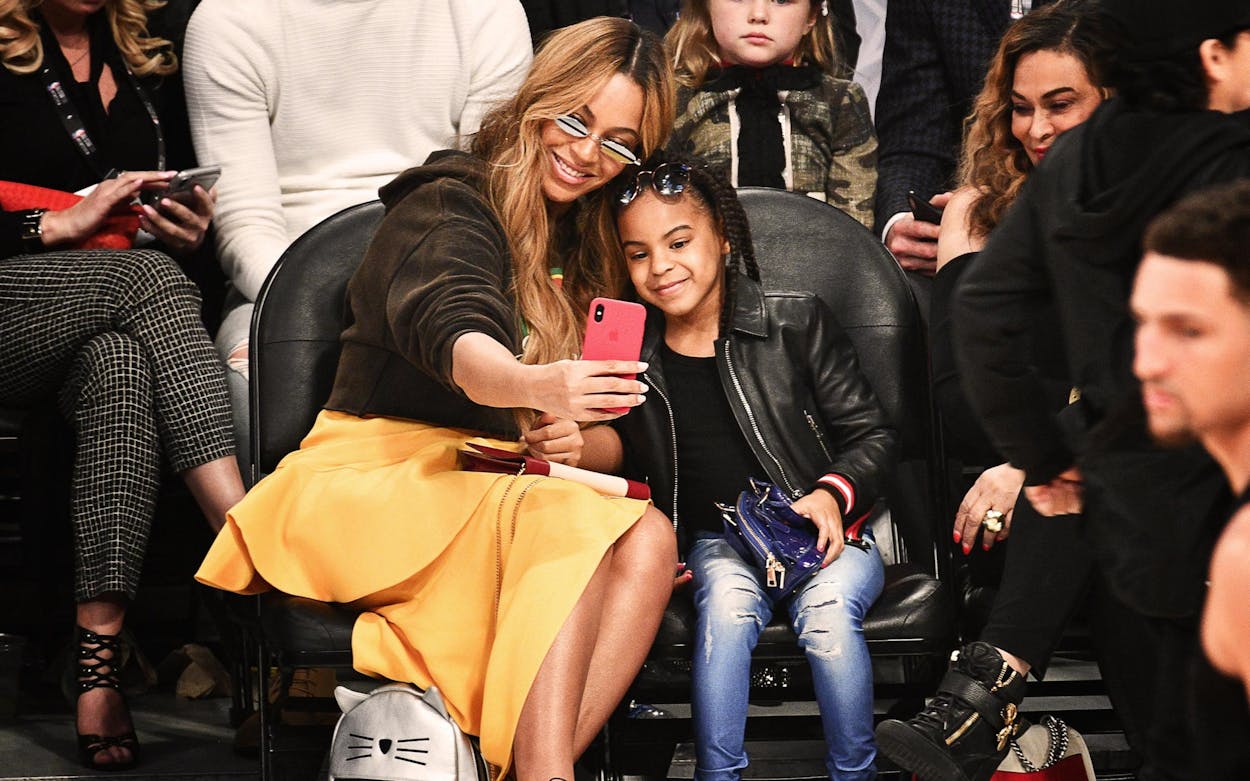 Blue Ivy Carter and Beyonce taking a selfie together.