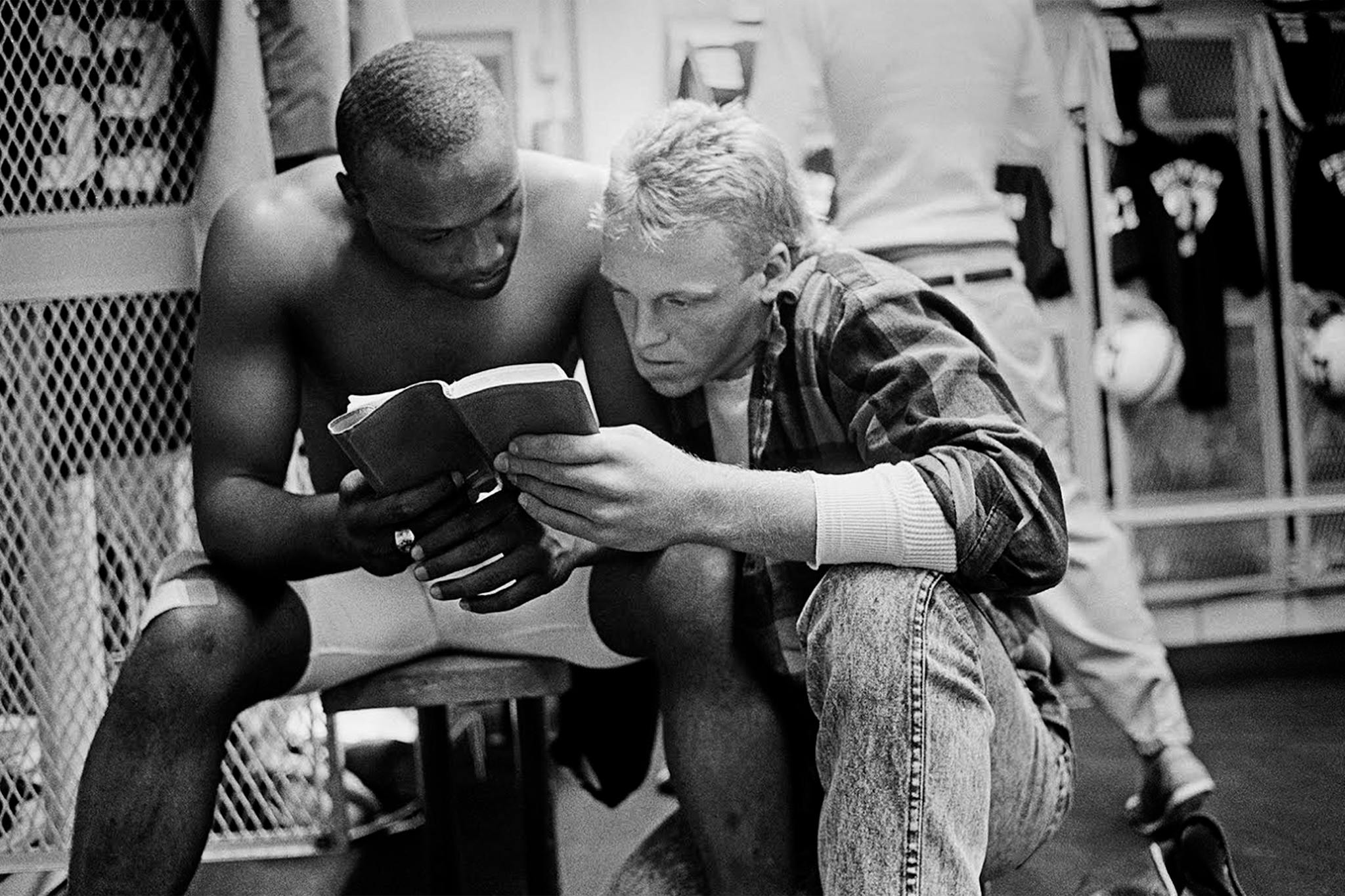 Friday Night Lights inspiration: football players Ivory Christian and Chad Payne read a Bible.