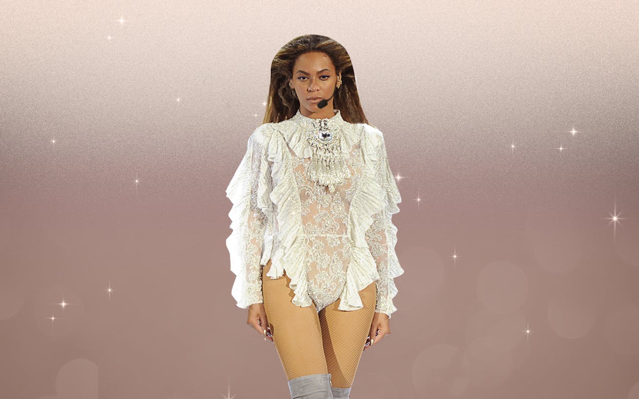 Beyonce performing in a white corset outfit.