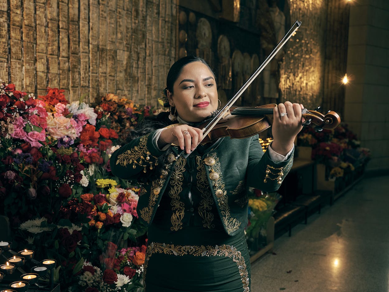 Cecilia Chavez plays her violin at the Basilica of Our Lady of San Juan del Valle in San Juan on October 18, 2020.