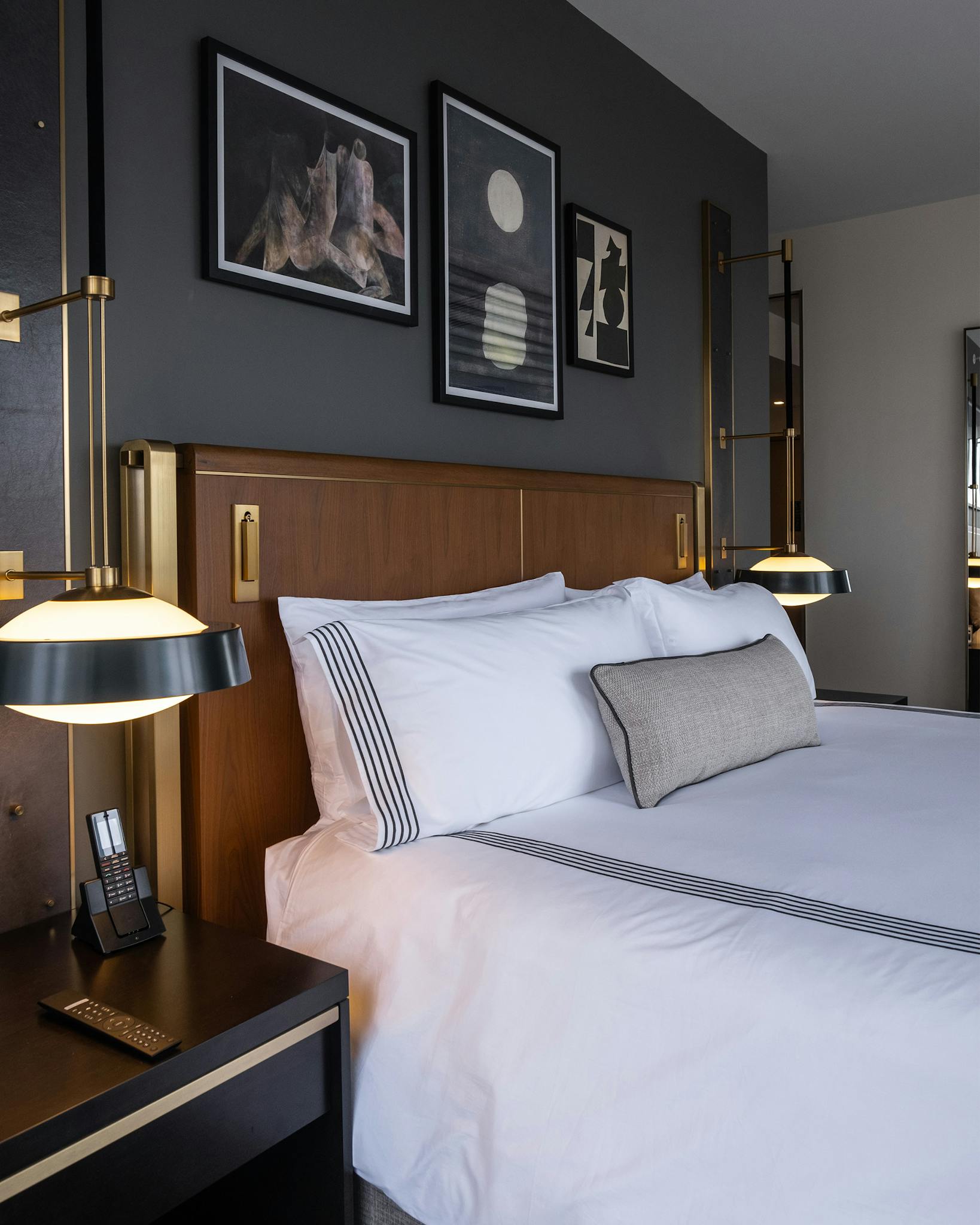 A sleek, contemporary room with white bedding in the Thompson Hotel.