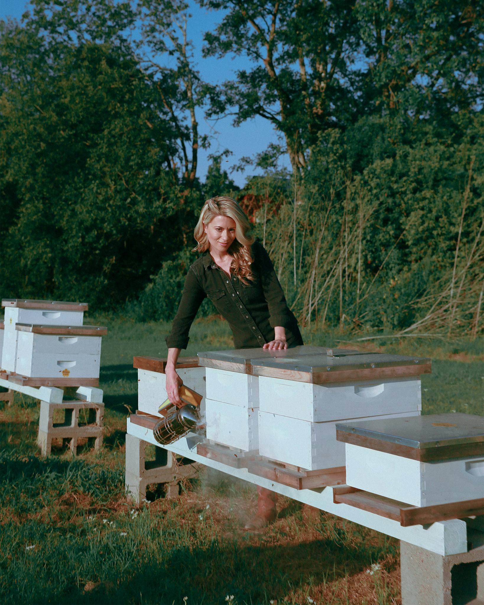 Erika Thompson tends to her bees outside her home in Elgin on September 18, 2020.