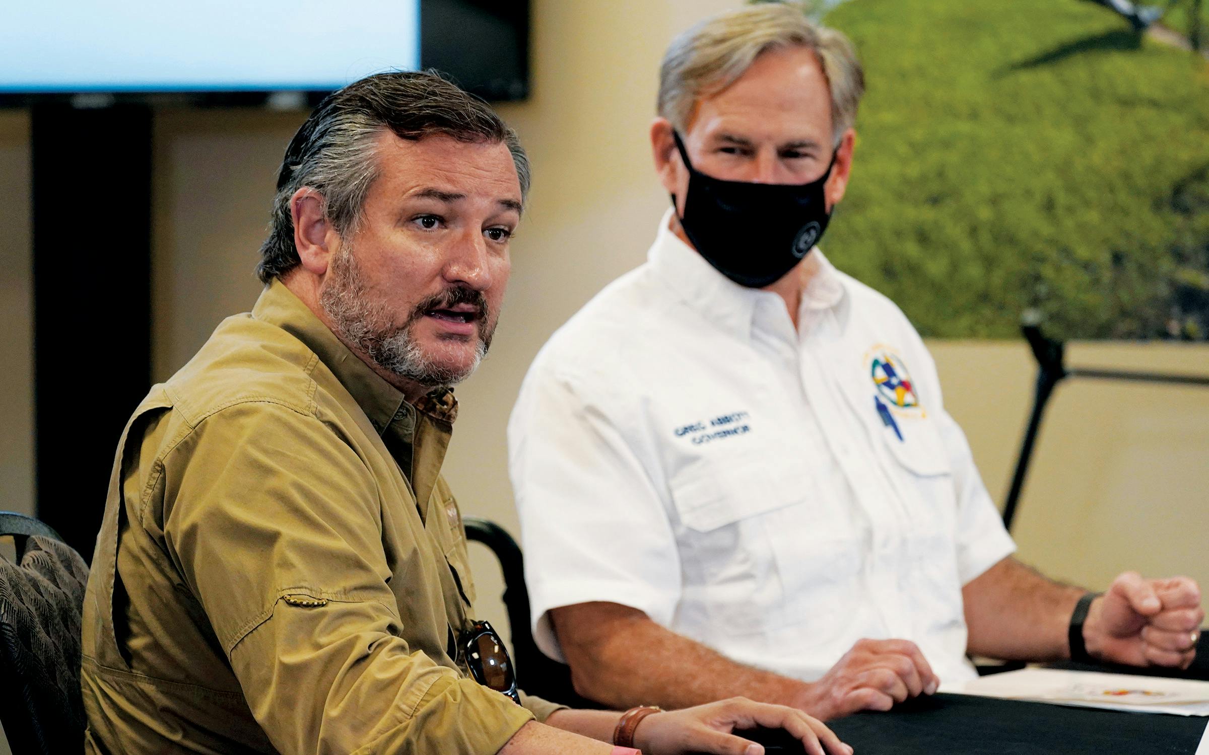 Senator Ted Cruz (left) and Governor Greg Abbott listen as President Donald Trump speaks during a briefing about Hurricane Laura, in Orange, on August 29, 2020.