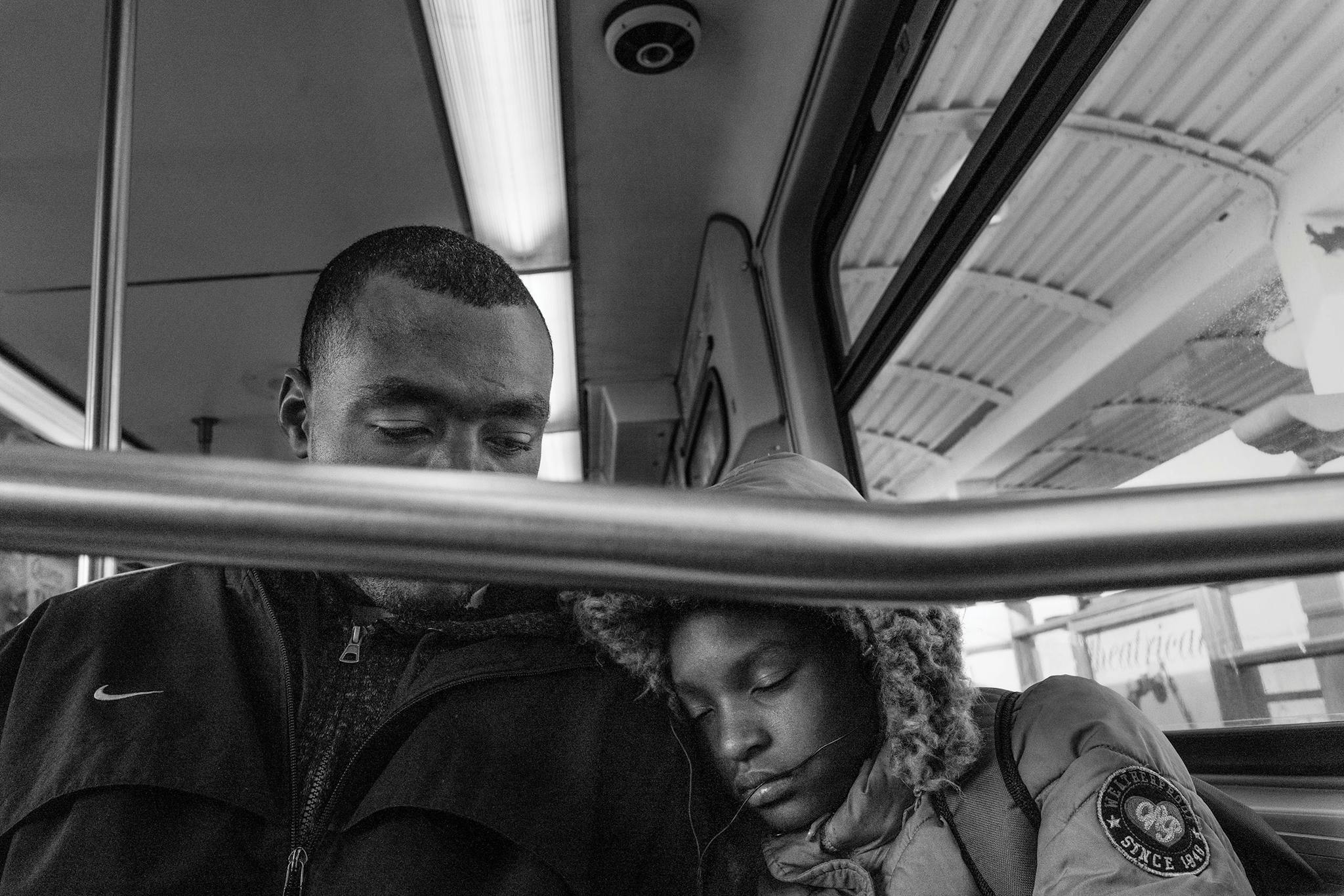 Twelve-year-old Devaiyah Buckner sleeps on her father Patrick’s shoulder on the train ride back from school.