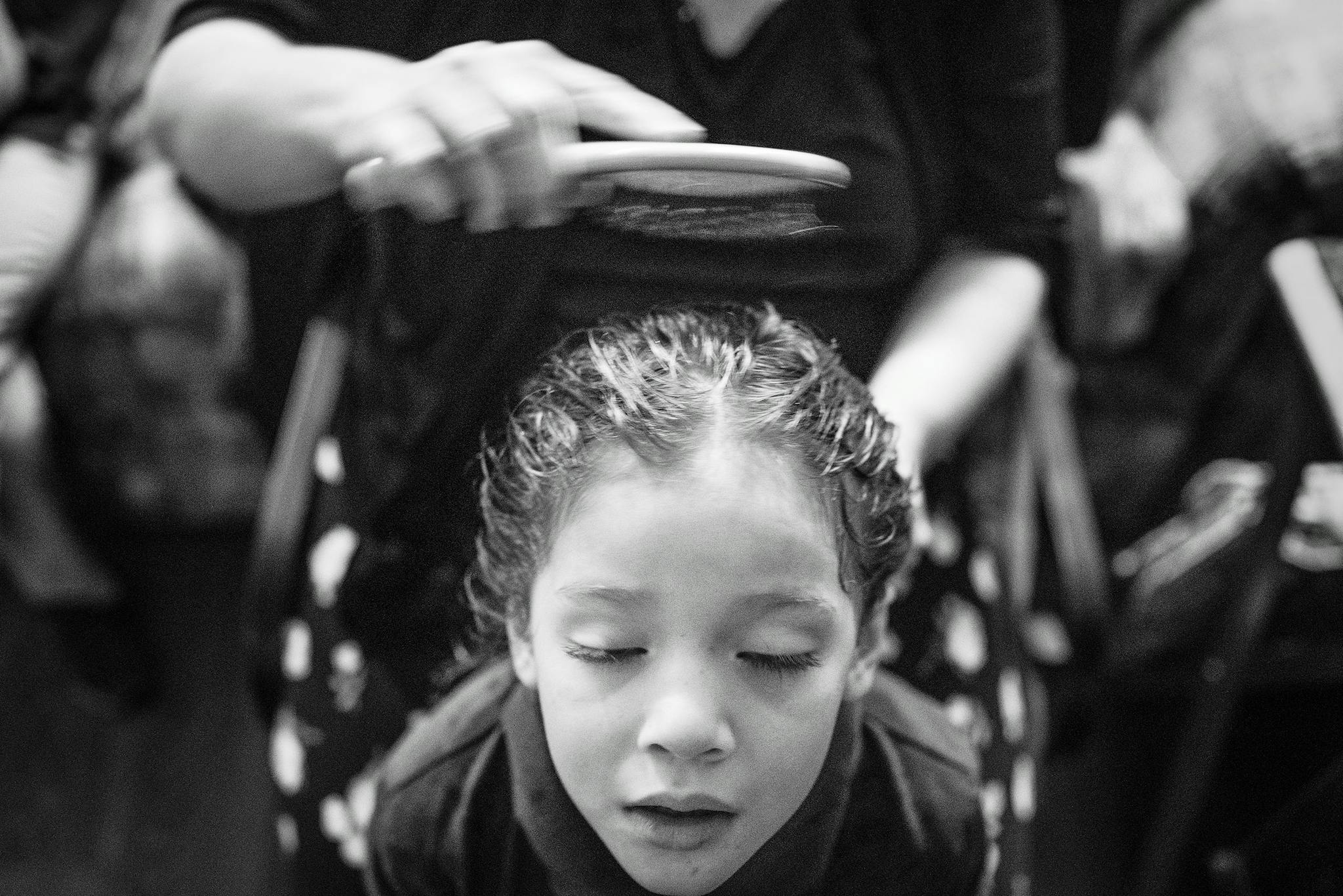 Kayla Isuala, four, has her hair brushed by her mother, Cindy, after her morning shower.