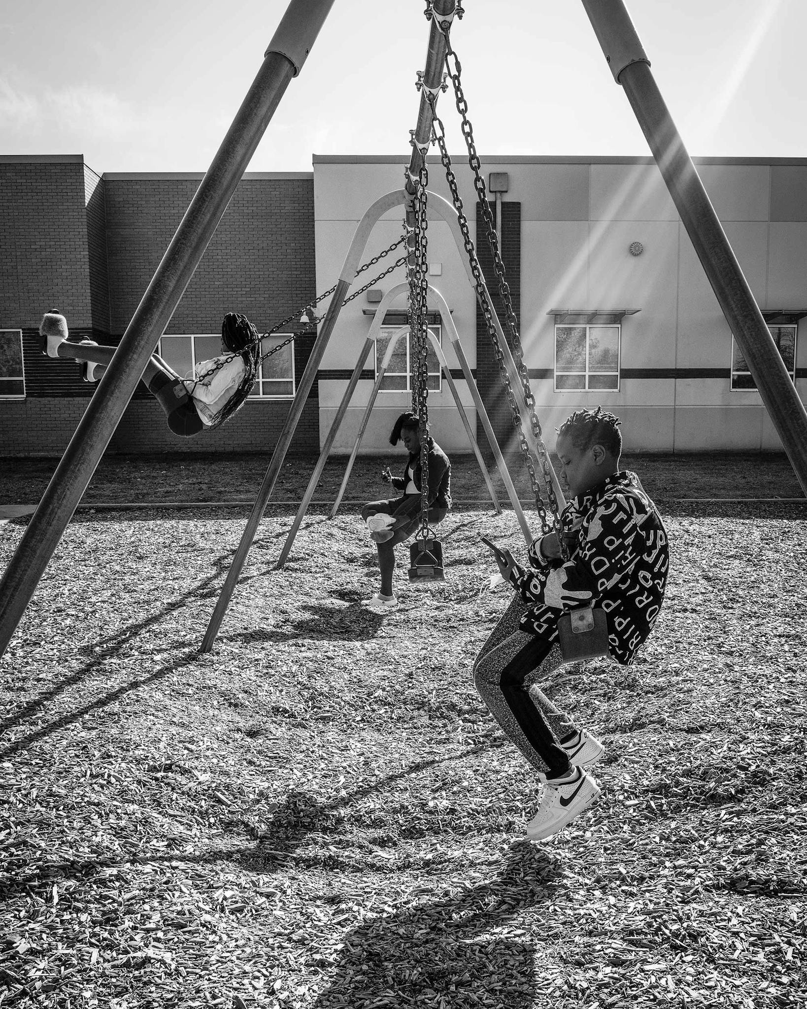 Johnson’s son Cavier, eleven, swings on a playground behind his elementary school, across the street from the Dallas apartment complex where he lives.