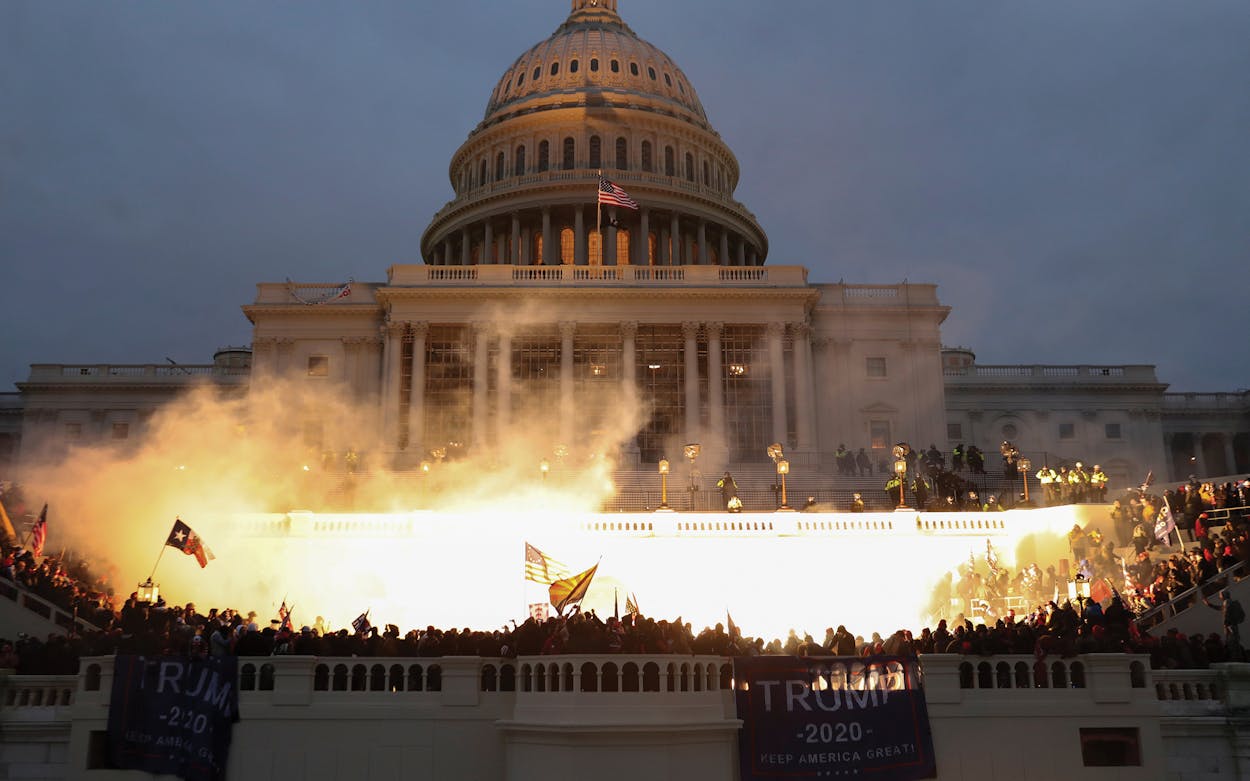 An explosion caused by a police munition is seen while supporters of U.S. President Donald Trump gather in front of the U.S. Capitol Building in Washington, U.S., January 6, 2021.