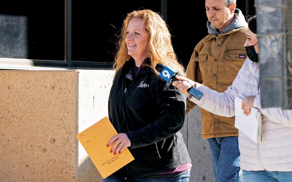 Jenny Cudd, front, a flower shop owner and former Midland mayoral candidate, and Eliel Rosa leave the federal courthouse in Midland, Wednesday, January 13, 2021. The FBI arrested Cudd and Rosa on Wednesday in connection with the January 6 insurrection at the U.S Capitol.