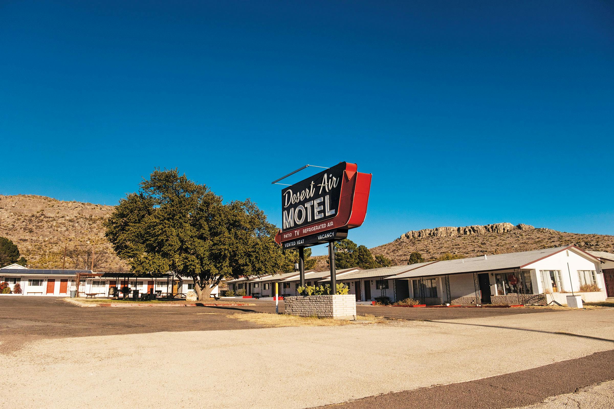 A motel in Sanderson against the mountains. 
