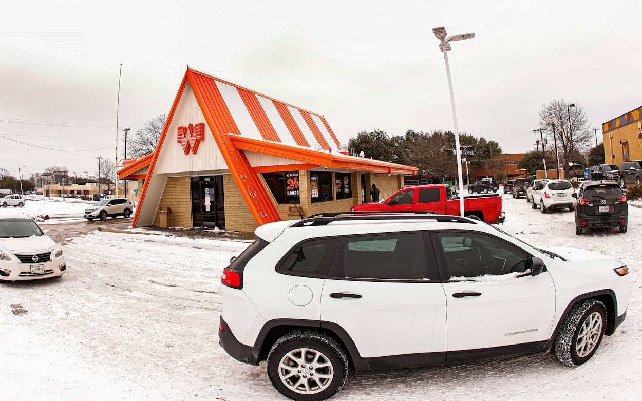 Cars wrap around a Whataburger as they line up to order food after a snow storm on February 17, 2021 in Fort Worth.