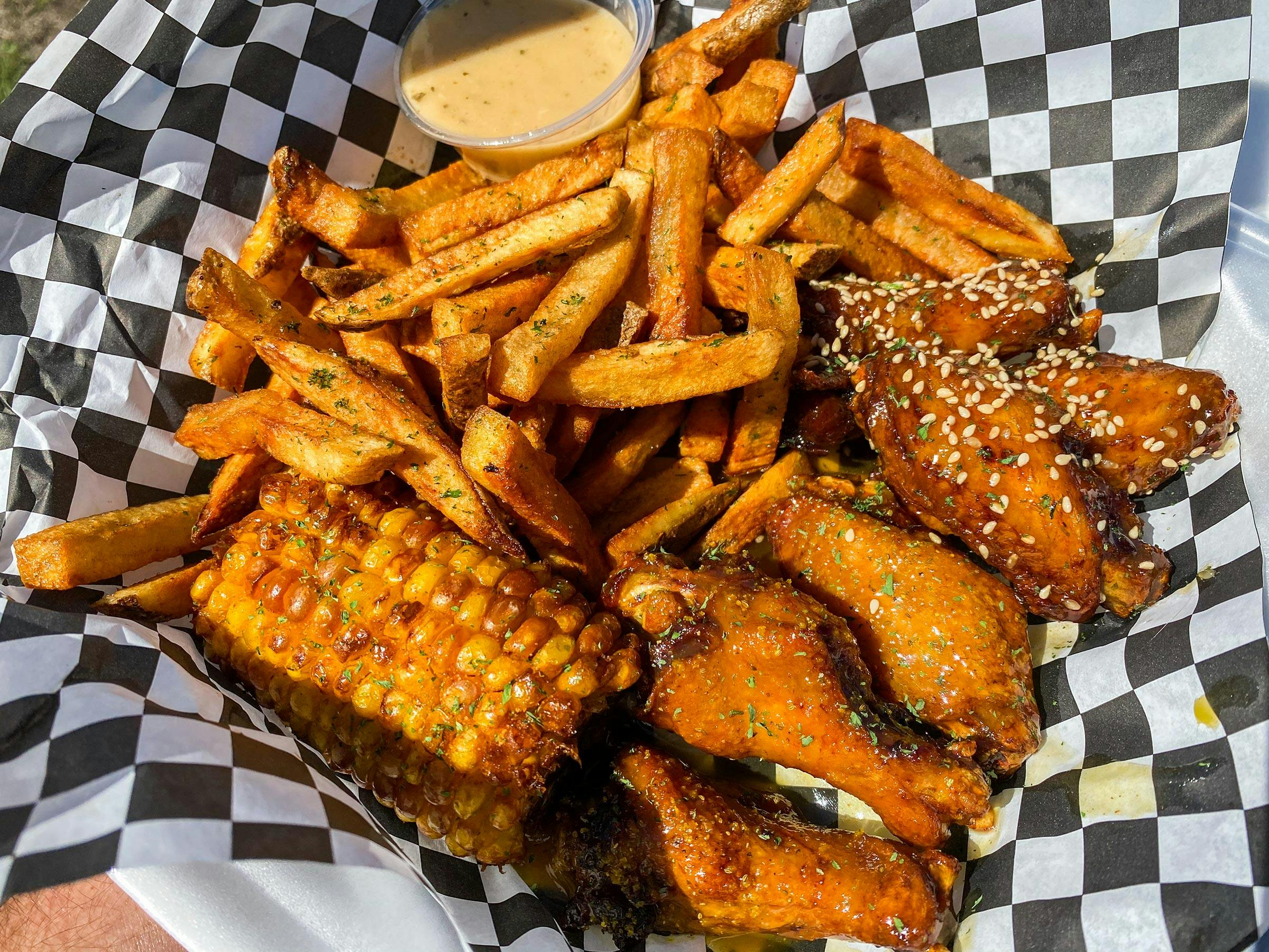 chicken wings with fried corn and French fries