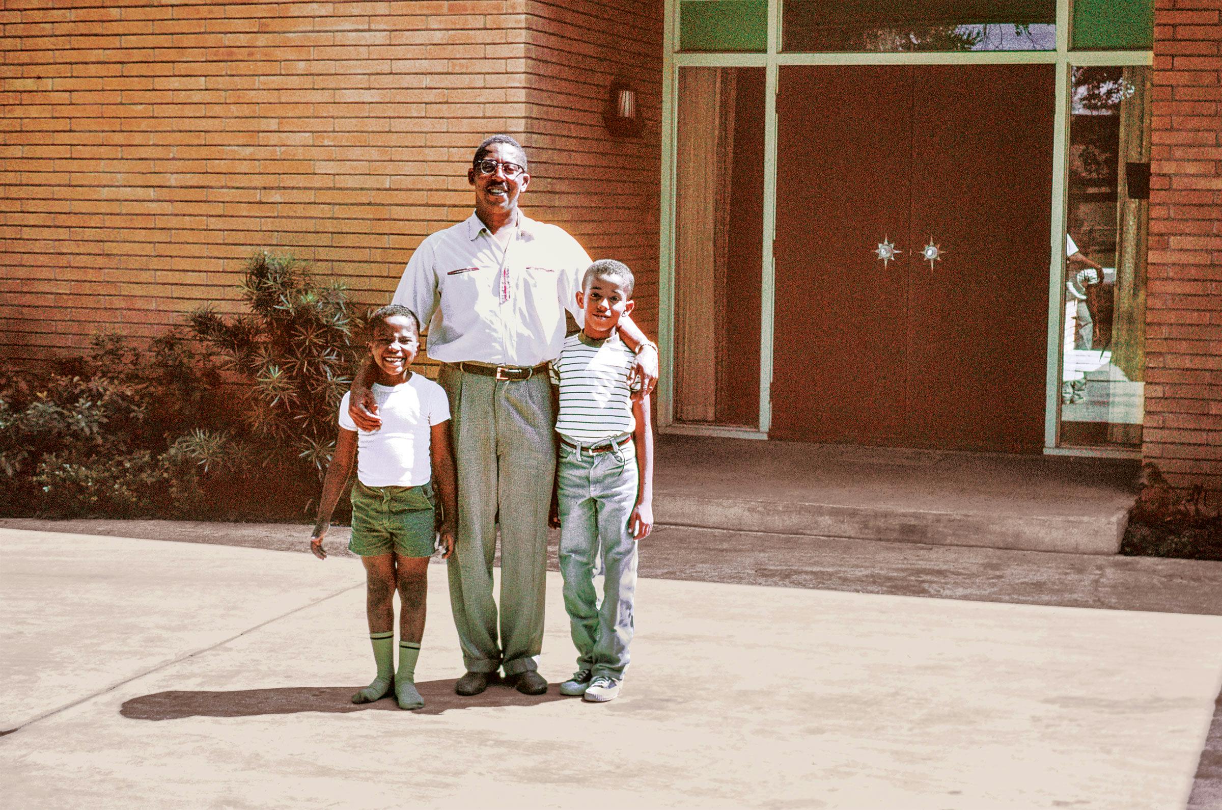 John S. Chase, with sons Anthony (left) and John (right), in front of the house, circa 1959.