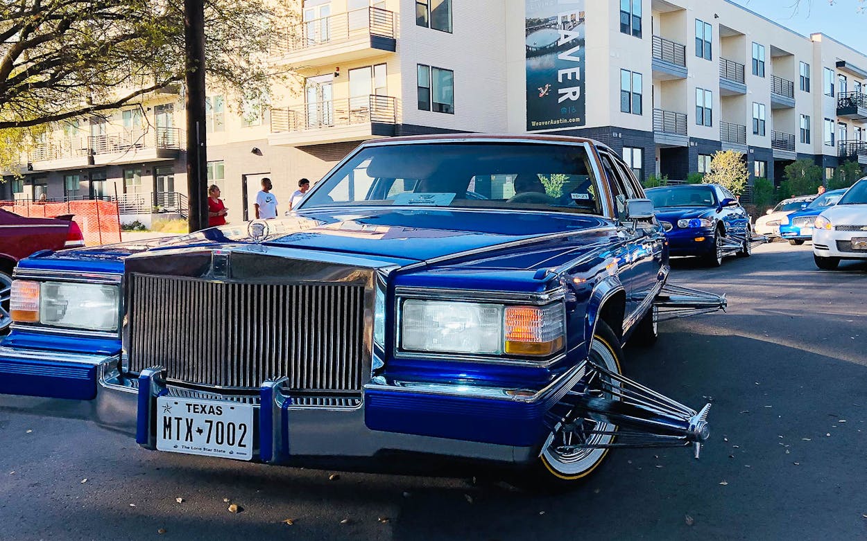 An electric blue vintage Cadillac at Austin car club—known as a 