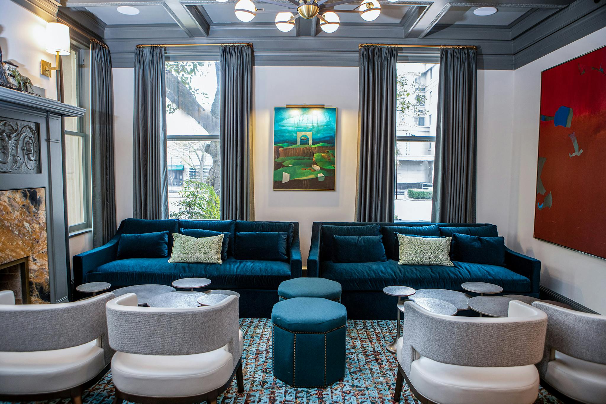 In the lounge, which was originally built as a library, a painting by Texas artist Lucas Johnson shares space with one by fellow Texan Dorothy Hood.