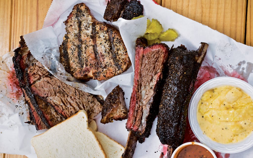 The offerings at offerings at JMuellerBBQ, which include ribs, pork chops, and brisket.