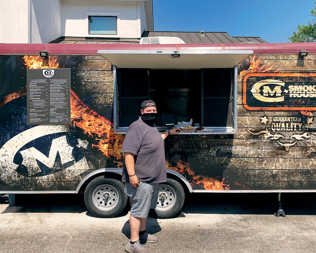Cade Mercer in front of the CM Smokehouse trailer in Austin. 