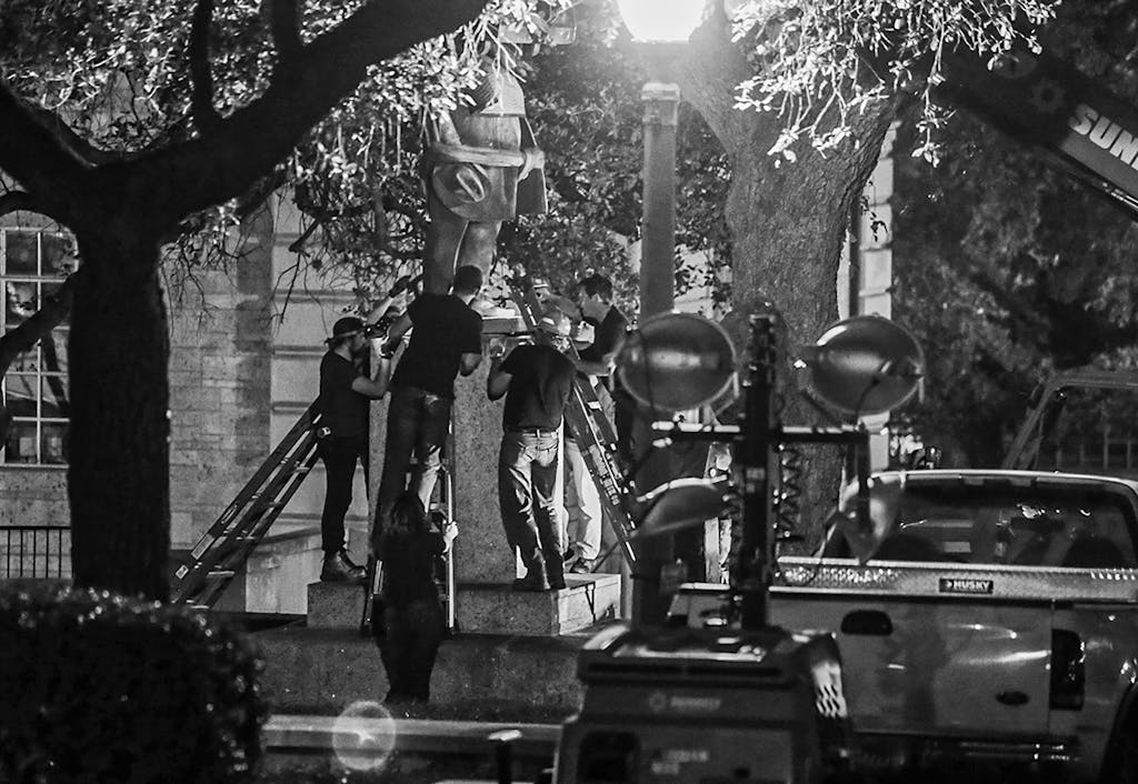 Confederate statutes including that of former Texas Governor James Hogg are removed from the University of Texas early Monday, Aug. 21, 2017, in Austin.