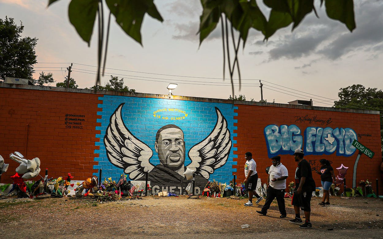 People visit a memorial and mural that honors George Floyd in Houston's Third Ward where Mr. Floyd grew up on June 8, 2020 in Houston.