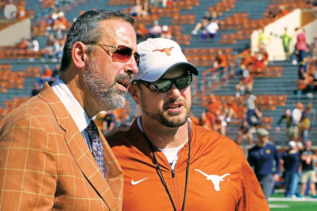 Texas athletic director Chris Del Conte with then–head coach Tom Herman.