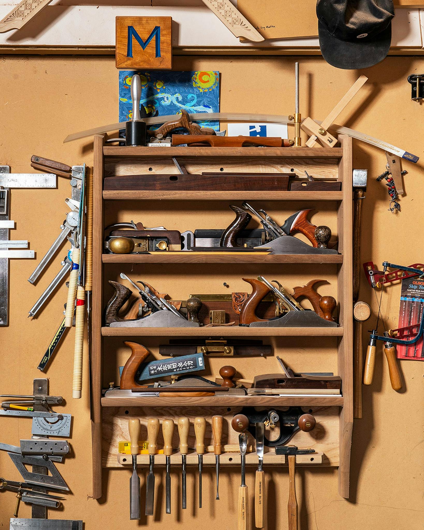 A tool rack which holds the various hand planes, saws, and other hand tools that Morley uses in his various projects.