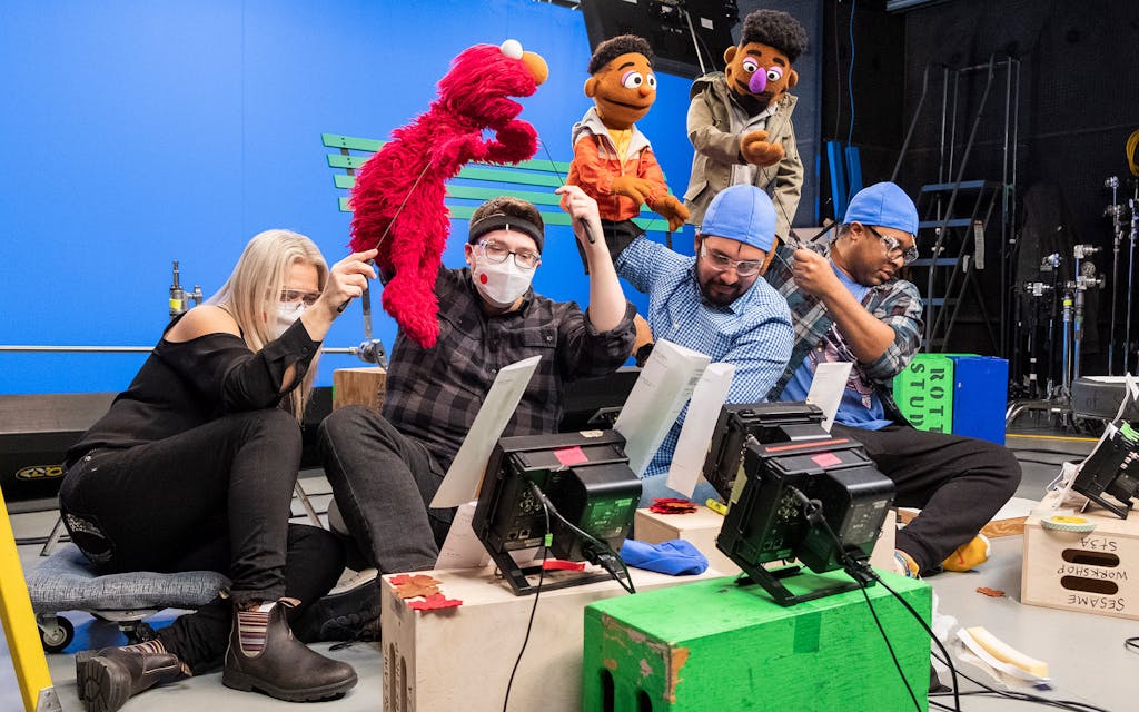 Bradley Freeman Jr. and other puppeteers filming an episode of the muppets.