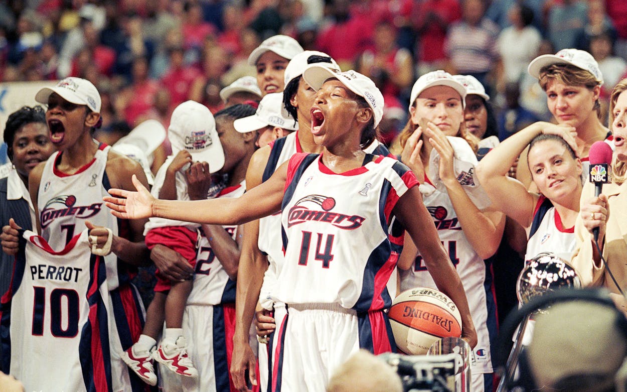 Cynthia Cooper, center, and the Houston Comets after winning game three of the WNBA Finals against the New York Liberty at the Compaq Center in Houston on September 5, 1999.