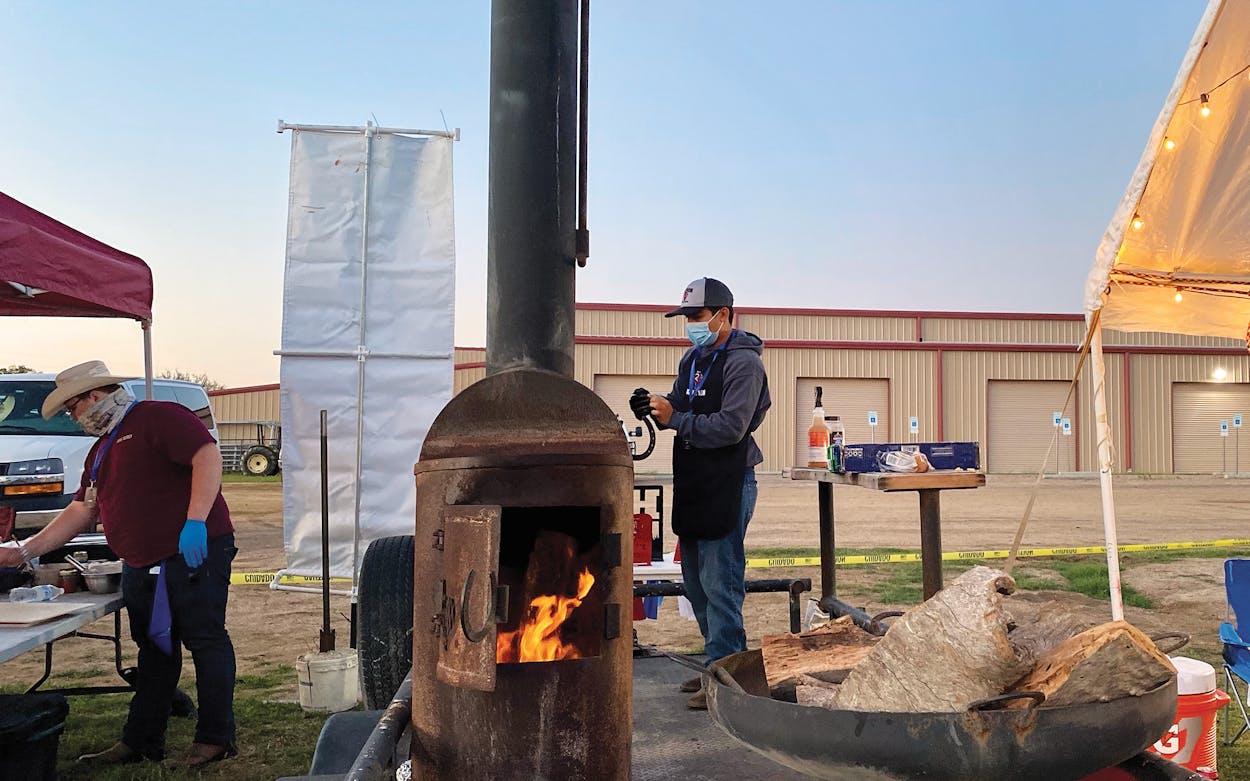Andres Reyes from Rankin High School manages his team's fire at the Texas State High School BBQ Championship on April 23, 2021.