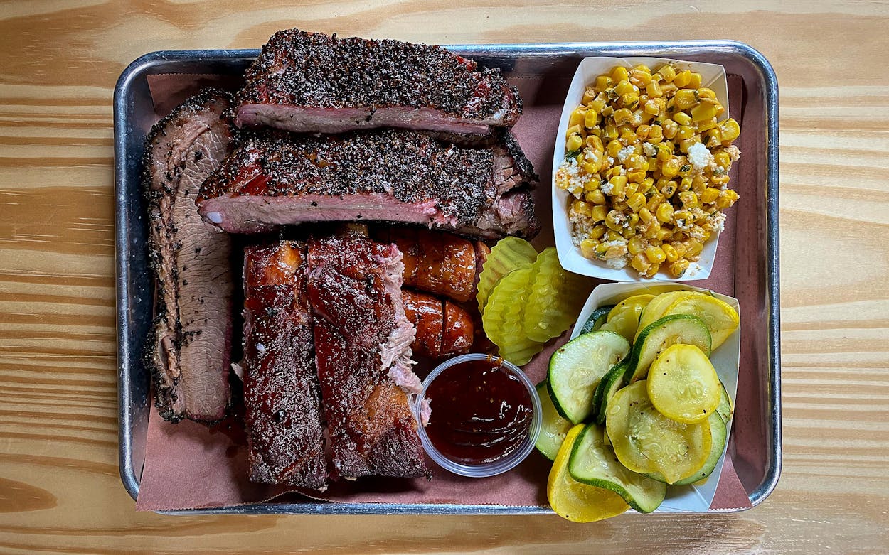 The spread at JW’s Barbecue, which includes savory smoked corn and a fresh vegetable side of squash and zucchini.