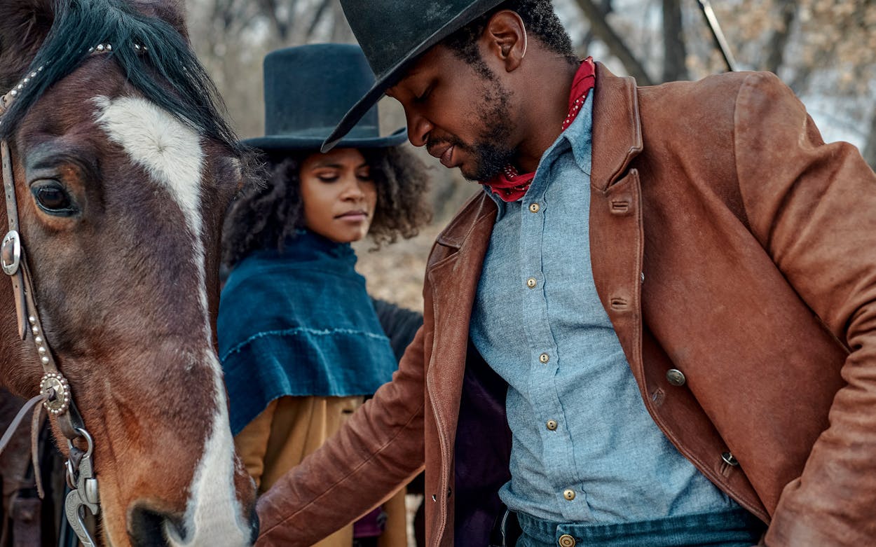 Still of Jonathan Majors, Zazie Beetz, and a horse in The Harder They Fall.