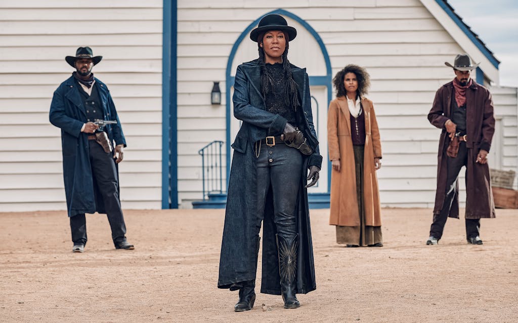 Still from The Harder They Fall of Regina King as Trudy Smith, Zazie Beetz as Mary Fields standing with guns drawn.