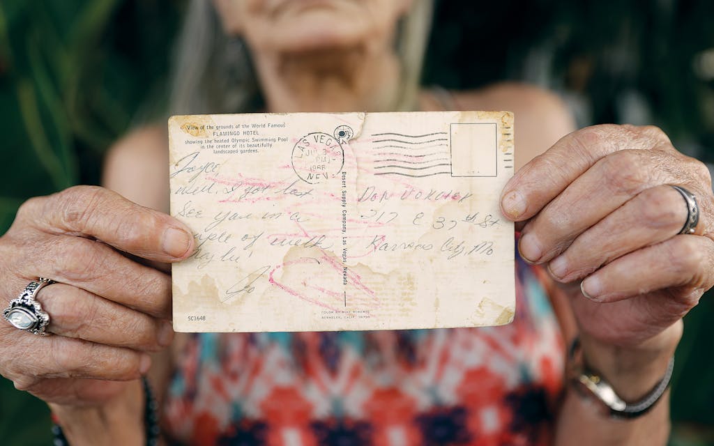 Pecos Jane identified as Jolaine Hemmy, and her sister, Joyce Hemmy, holds a postcard she received shortly after her disappearance. 